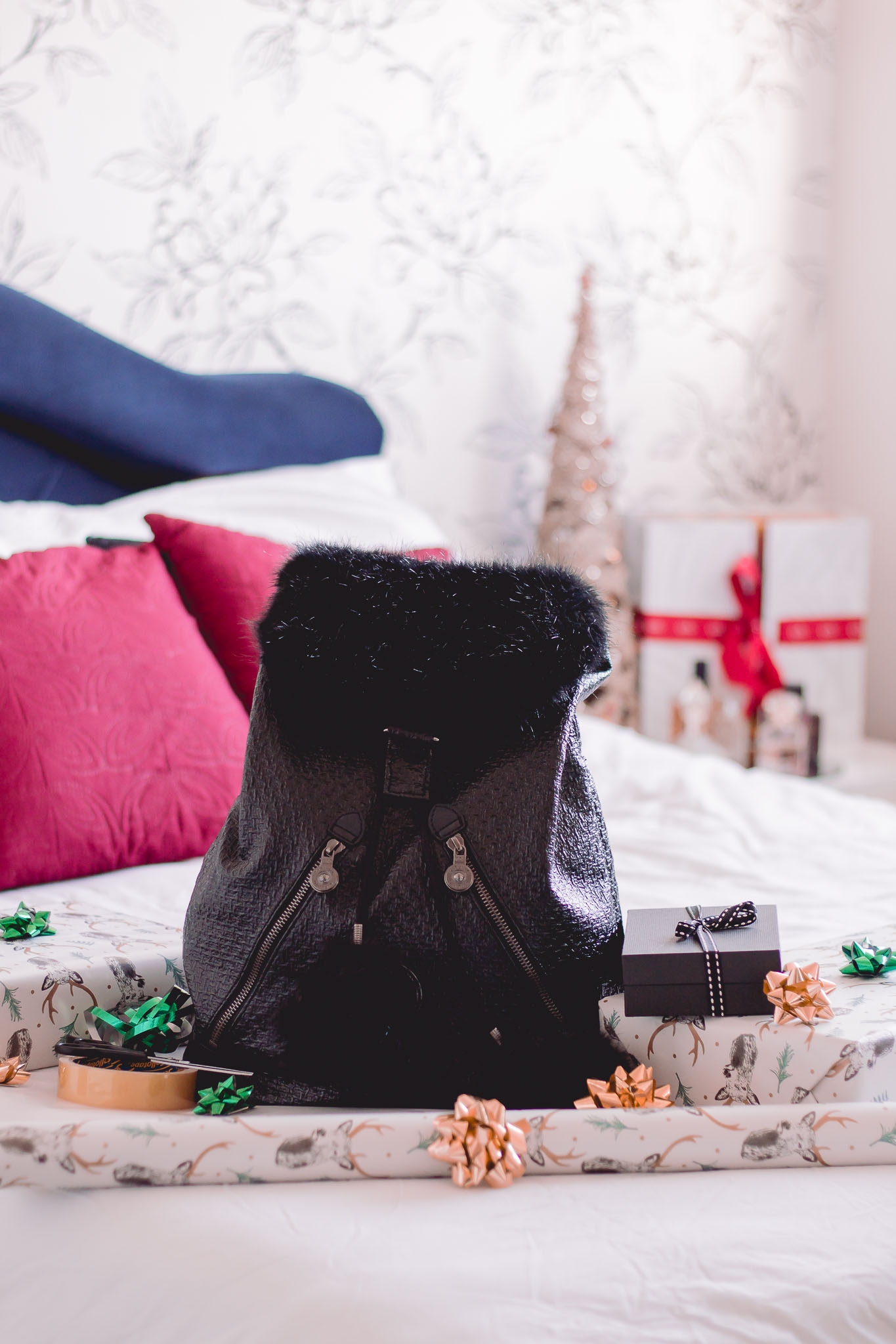 kipling bag on bed with gifts and gift wrapping